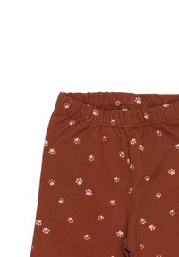 Brown cotton leggings featuring a scattered pattern of light pink paw prints. Elastic waistband for comfort. Soft, stretchy fabric texture.