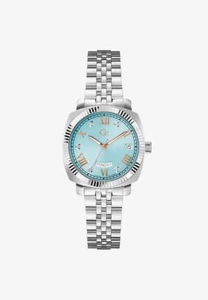 Zilveren horloge van roestvrij staal met een turkooizen wijzerplaat, Romeinse cijfers, diamanten accenten en een dag-datumweergave. Voorzien van een schakelarmband.