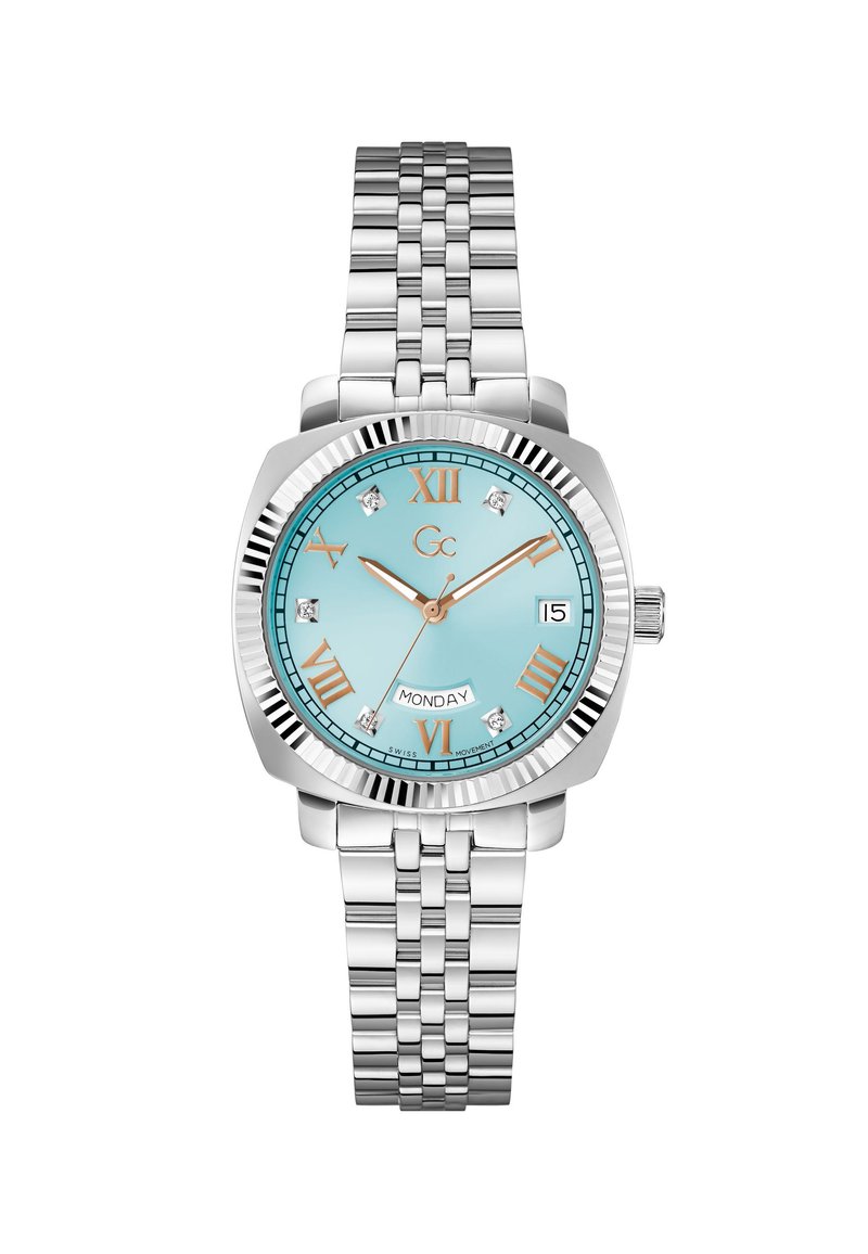 Montre en acier inoxydable argentée avec un cadran turquoise, des chiffres romains, des accents en diamant et un affichage jour-date. Comprend un bracelet à maillons.