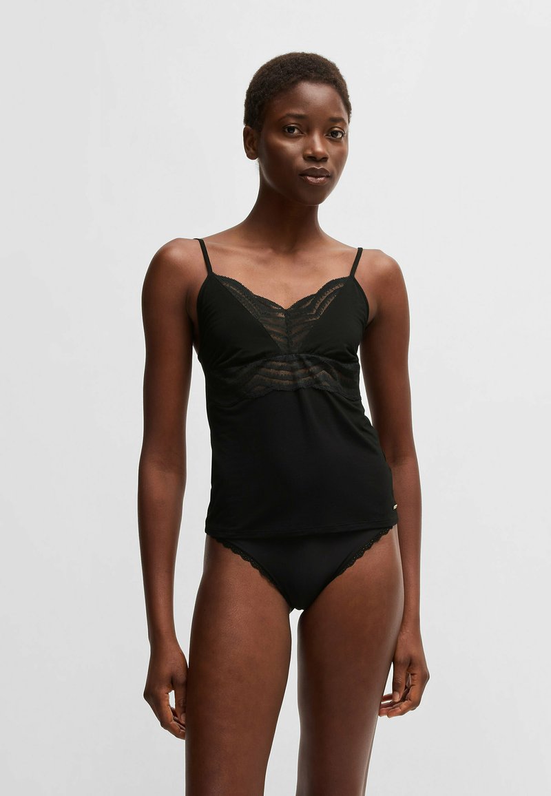 Czarny top na ramiączkach z koronkowym wykończeniem przy biuście, cienkimi ramiączkami i dopasowanym krojem. W zestawie z pasującą czarną bielizną wykończoną koronką.