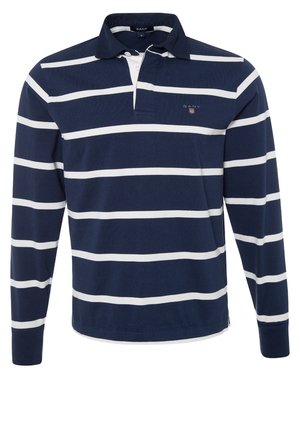 Chemise de rugby à manches longues bleu marine avec des rayures blanches horizontales, un col, une patte à trois boutons et un petit logo GANT sur la poitrine gauche.