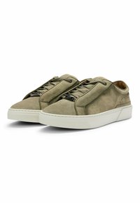Light olive green suede sneakers with a rounded toe, lace-up design, and white rubber sole. Features textured accents and a smooth interior lining.