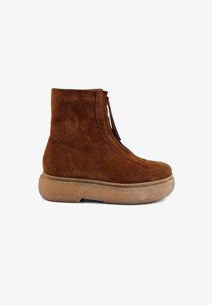 Brown suede ankle boots with a round toe, side zipper, and a thick, textured, light brown platform sole.