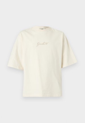 Off-white oversized short-sleeve t-shirt with round neck and "GmbH" scripted logo centered on the chest.