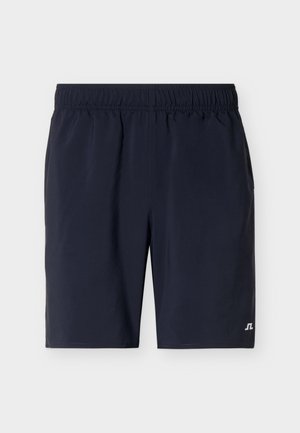 Pantalones cortos de cintura elástica azul marino con piernas rectas y pequeño logo blanco en el dobladillo inferior izquierdo.