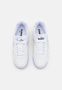 White sneakers with a perforated leather upper, light blue accents, mesh tongue, and white laces. Textured sole and logo on the insole.