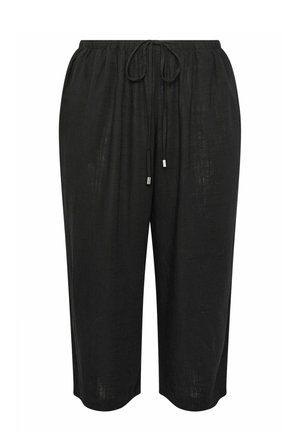 Pantalones negros holgados y recortados con cintura elástica y cordón delantero con puntas metálicas.