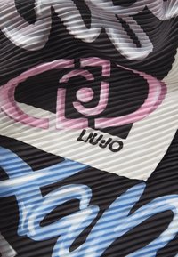 Kangas mustal põhjal ja värvikate abstraktsete mustritega roosa, valge ja sinise tooni, millel on must logo "LIU JO". Tekstuuritud, sooniline pind.