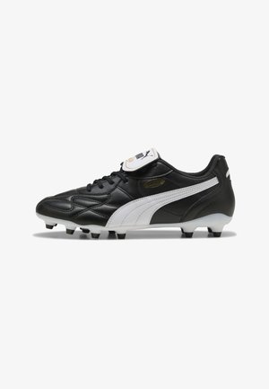 Black synthetic soccer cleat with white side accents, textured surface, and six black studs. Features laces and branding on tongue.