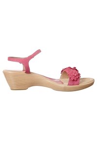 Pink wedge sandals with floral accents, made of suede. Features an ankle strap and a contoured wooden base with a textured finish.