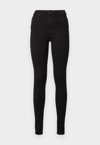 Jeans negros ajustados de mezclilla con cintura alta, que presentan una silueta entallada, cinco bolsillos y trabillas para cinturón. Textura suave.