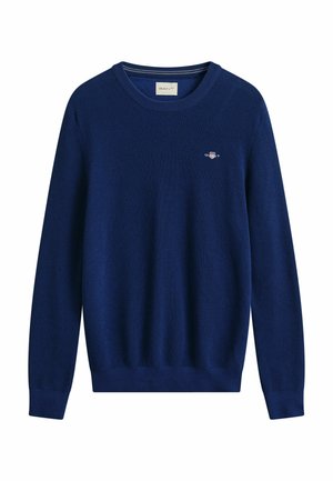 Navy blue knitted crewneck sweater with long sleeves and small embroidered logo on the chest.