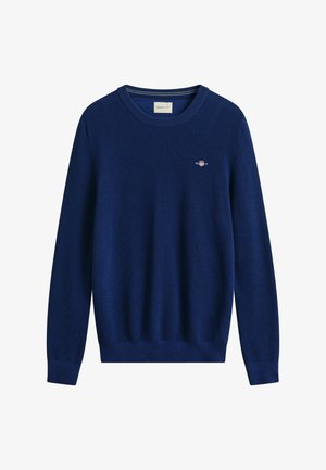 Navy blue knitted crewneck sweater with long sleeves and small embroidered logo on the chest.