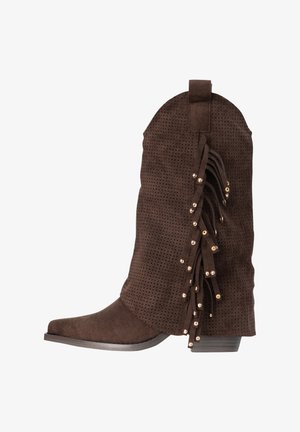 Bota de vaquero de ante marrón con parte superior perforada, detalle de flecos adornados con tachuelas doradas y tacón bajo apilado.