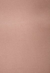 Light pink stretchy fabric with a ribbed texture, showcasing a smooth, even surface. Slight sheen; no visible patterns or accents.