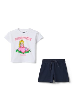 Camiseta blanca de manga corta con gráfico de la Princesa Peach y texto "¡Qué melocotón!" combinada con pantalones cortos lisos azul marino con cordón.