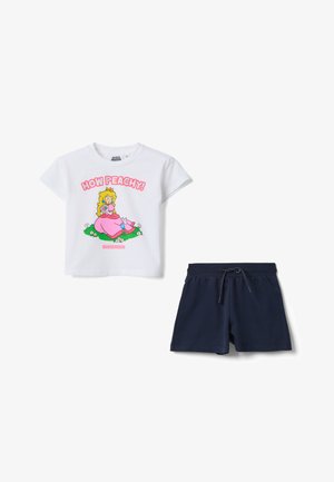 T-shirt blanc à manches courtes avec un motif de la Princesse Peach et le texte "How Peachy!", associé à un short à cordon bleu marine uni.