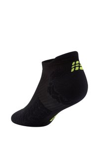 Schwarze Knöchelsocken mit einem strukturierten Muster und neonfarbenen Akzenten. Hergestellt aus einem atmungsaktiven Material mit verstärkten Fersen- und Zehenbereichen.