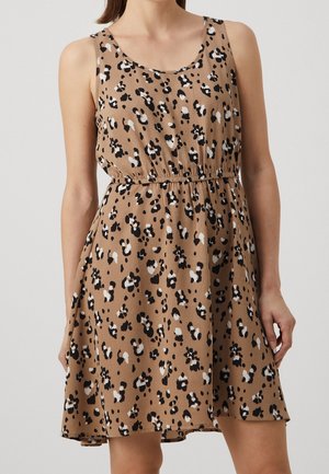 Sleeveless knee-length beige dress with black, white, and brown abstract floral print and elastic waist worn by a woman.