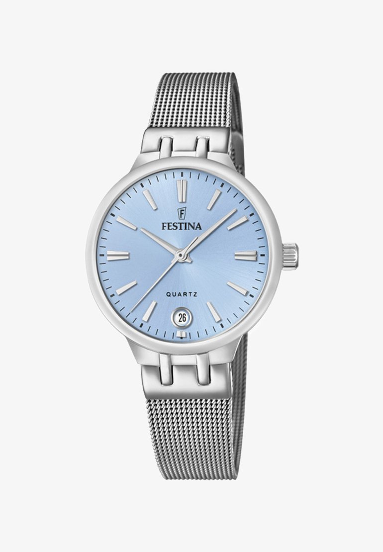 Sudraba metāla rokas pulkstenis ar apaļu zilu ciparnīcu, sudraba stundu marķieriem un metāla sietiņu. Iespējo datuma logu pulksteņa 6 stundu pozīcijā.