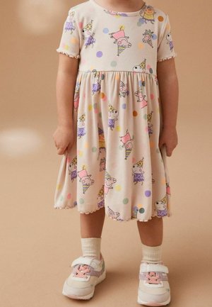 Robe à manches courtes en tissu côtelé doux avec une base beige clair et des pois colorés. Elle présente des personnages de dessins animés ludiques et un ourlet festonné.