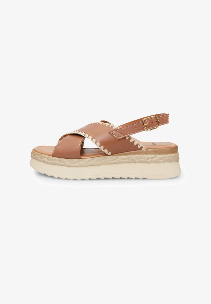 Brown leather sandals with cross strap design, adjustable ankle buckle, woven jute midsole, and lightweight white rubber outsole.