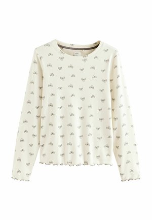 Top a maniche lunghe color crema chiaro con una texture a coste, caratterizzato da un motivo a fiocchi ripetuto in grigio scuro e orlo smerlato.