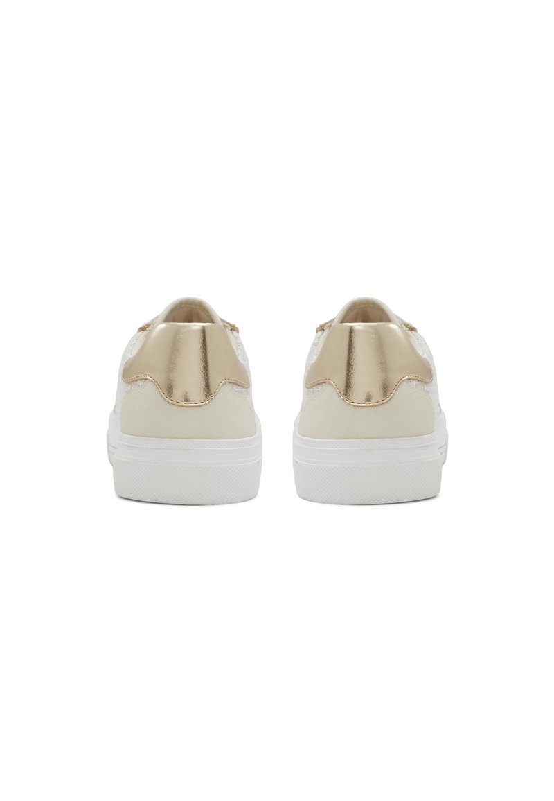 Zapatillas blancas con un acento dorado metálico en el talón y detalles texturizados en la parte superior. Presenta una suela blanca gruesa.