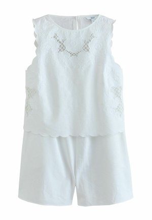 Weißes ärmelloses Oberteil mit floraler Spitze und gezackten Rändern kombiniert mit passenden weißen Shorts.