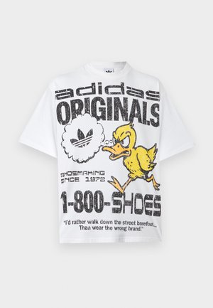White Adidas Originals t-shirt featuring a distressed black logo, an angry yellow duck cartoon, and text promoting shoemaking since 1972.