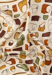 Fabric featuring an array of illustrated handbags in various shapes and colors: brown, green, orange, yellow, and neutral tones on a cream background.