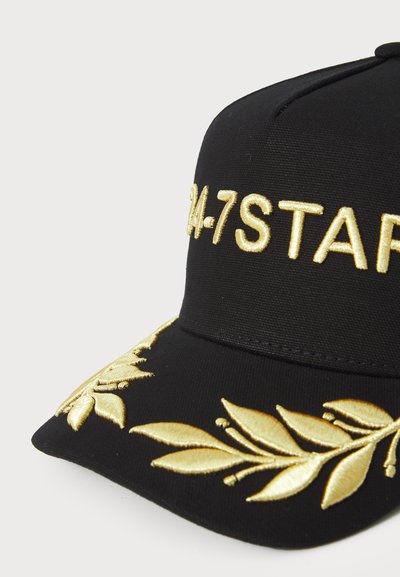 Black baseball cap with gold embroidered "24-7STAR." Features gold leaf patterns along the brim, textured fabric, and curved peak.