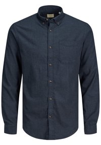 Tummansininen, pitkähihainen napillinen paita, valmistettu teksturoidusta kankaasta ja varustettu rintataskulla sekä ruskeilla napeilla.