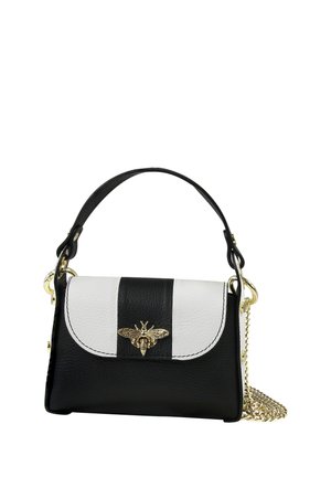 Black and white leather handbag with a gold bee emblem on the flap, black handle, and gold chain strap coiled at the side.