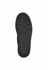 Semelle de chaussure noire présentant un motif texturé et nervuré avec des rainures profondes pour une meilleure adhérence. Forme ovale avec des bords bien définis et sans marquage visible.