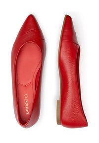 Červené kožené baleríny s špičatou špičkou, které mají dekorativní křížkový design a hladký povrch. Podešev je plochá a v béžové barvě.