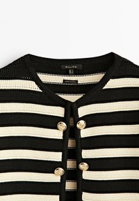 Cardigan en maille à rayures noires et beiges avec un col rond et quatre boutons décoratifs dorés au centre devant.
