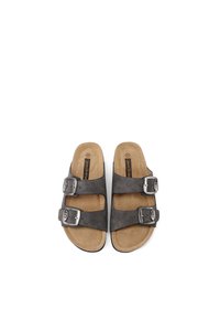 Sandali in suede grigi con due fasce regolabili, fibbie metalliche argentate e sottopiedi marrone chiaro, caratterizzati da una punta rotonda e suola piatta.