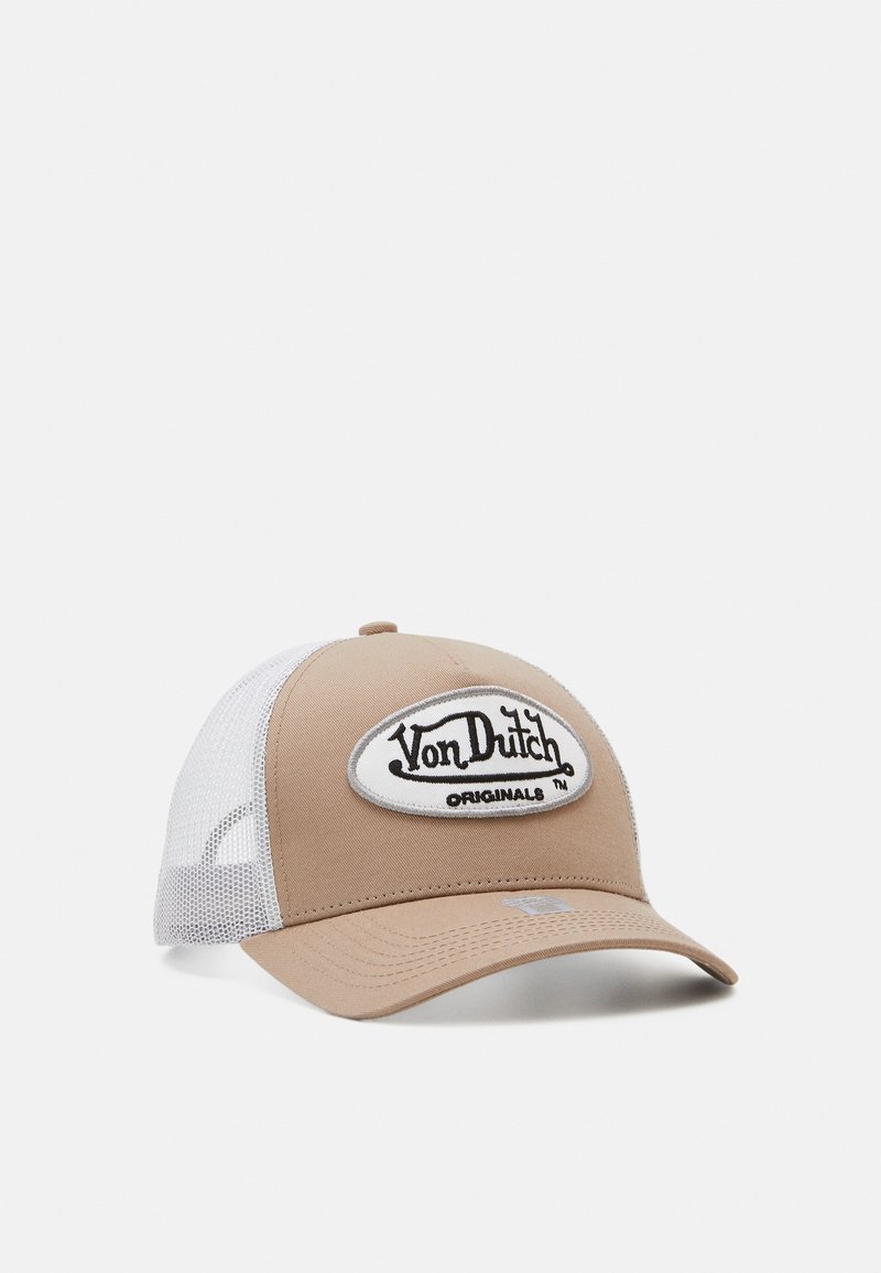 Trucker cap with a beige front panel and white mesh back, featuring an embroidered black logo patch. Curved brim design.