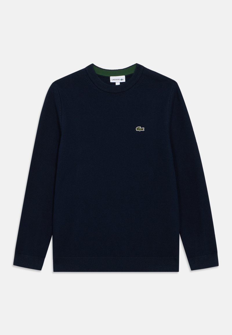 Suéter azul marino de material de punto, con cuello redondo, mangas largas y un pequeño logo verde de Lacoste en el pecho.