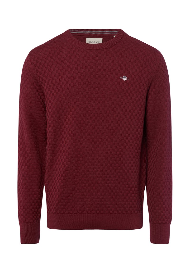 Bordeauxfarbener Pullover mit strukturiertem Wabenmuster, runder Ausschnitt und gerippten Bündchen und Saum. Kleines Logo auf der Brust.
