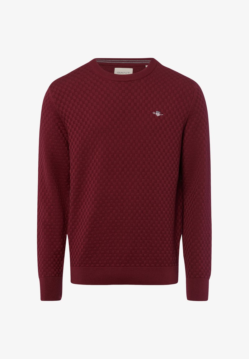 Bordeauxfarbener Pullover mit strukturiertem Wabenmuster, runder Ausschnitt und gerippten Bündchen und Saum. Kleines Logo auf der Brust.