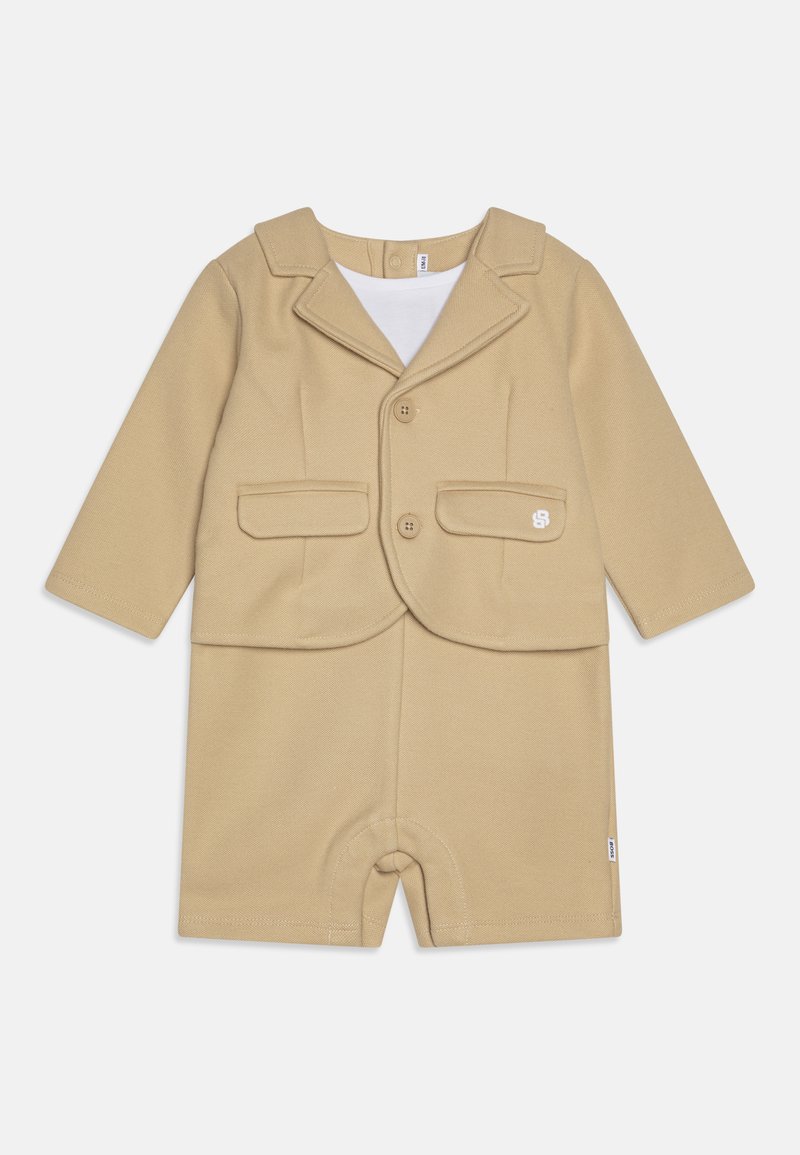 Beige two-piece outfit featuring a blazer with lapels, two front pockets, and matching shorts. Made from smooth fabric with visible stitching.