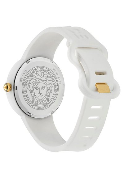 Montre en silicone blanche avec un boîtier rond, un bracelet texturé et une couronne dorée. L'arrière présente une gravure de Méduse et un motif à clés grecques.