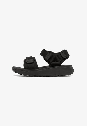 Zwarte sandalen met rubberen zolen, voorzien van verstelbare banden en een gestructureerde voetbed. Het ontwerp heeft een ondersteunende enkelband.