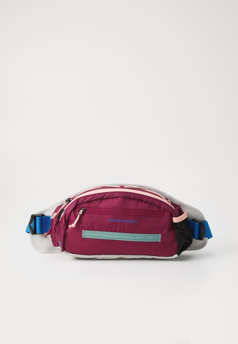 Fanny pack in deep purple and gray. Features multiple zippered compartments, adjustable blue strap, and brand logo on the front.