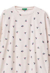 Jasnoróżowa bluza z nadrukiem z zielonych liści i czerwonych jagód na całej powierzchni. Miękka w dotyku i o luźnym kroju. Okrągły dekolt i długie rękawy.