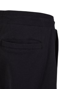 Mustat collegehousut, joissa on ribbikuvioitu vyötärö, takatasku ja pehmeä kangas, suunniteltu mukavuutta ja rentoa käyttöä varten.