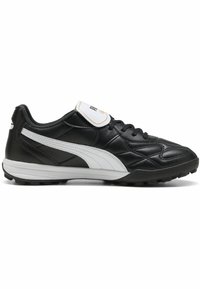 Zapatilla de fútbol sintética negra con acentos blancos, diseño con cordones, lengüeta acolchada, superficie texturizada y suela de goma moldeada para tracción.