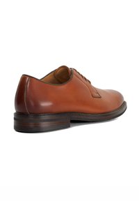 Brown leather dress shoe featuring a rounded toe, smooth finish, subtle stitching, and a low-profile wooden heel. Classic lace-up design.